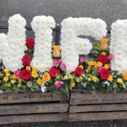 FUNERAL LETTERS SITTING ON A BED OF ROSES